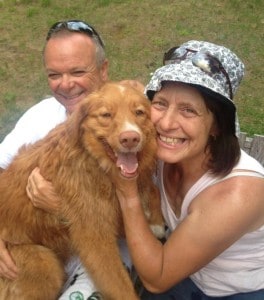 Photo of Monica and Serge Gazzola and thier dog. Happy Confederation Log & Timber Frame home owners.
